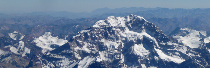 A mountain with snow on it's side.