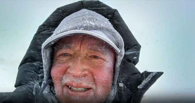 A man with a hat and jacket on.