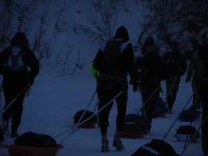 A group of people walking in the snow.
