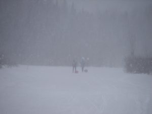A group of people standing in the snow.