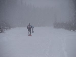 A person is walking in the snow on skis.