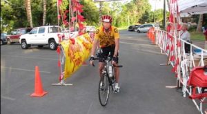 A man riding a bike down the street.