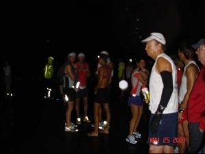 A group of people standing around in the dark.