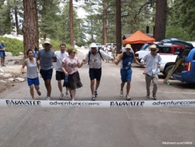 A group of people running in the forest.