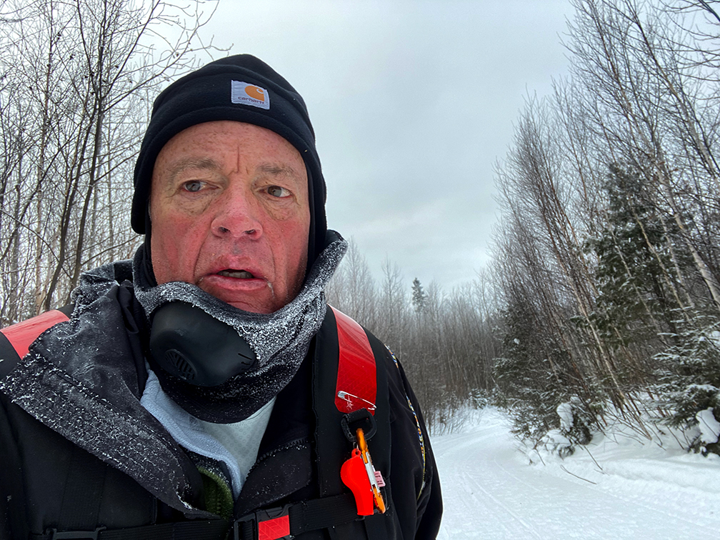 A man in the snow wearing winter clothing.